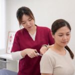 Ivy from One Spine demonstrating a low-force Activator chiropractic method in clinic