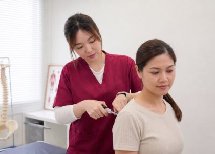 Ivy from One Spine demonstrating a low-force Activator chiropractic method in clinic