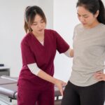 Ivy from One Spine assessing hip and pelvis movement in a clinic setting