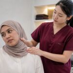 One Spine TTDI practitioner assessing persistent neck pain for a patient